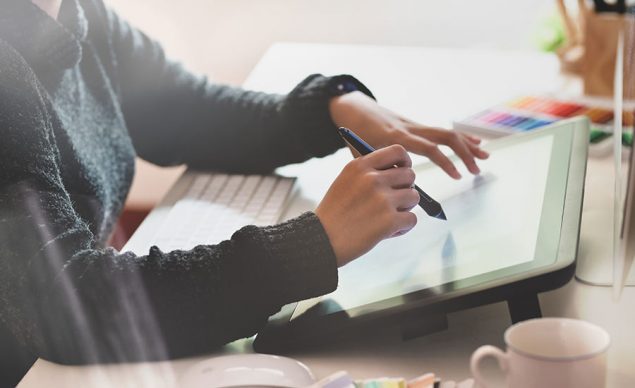 Stock illustration showing a person using a drawing tablet. Image used in the “What Drawing Tablet Should You Get” blog post.​