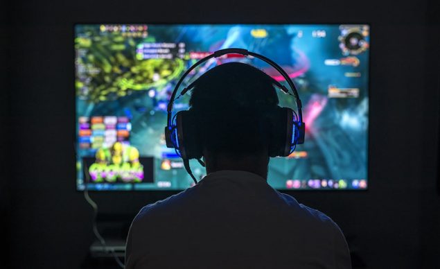 A stock image of a man playing a video game. Image used in the “2023 Game Releases To Look Out For ” blog post.​